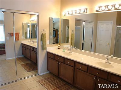 62195 East Northwood Road Tucson, AZ 85739 - Photo 18 of 25 a bathroom with a double vanity sink mirror and double