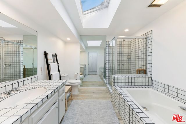 a kitchen with granite countertop a stove a sink and a refrigerator