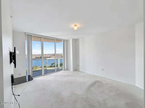 a view of an empty room and a window