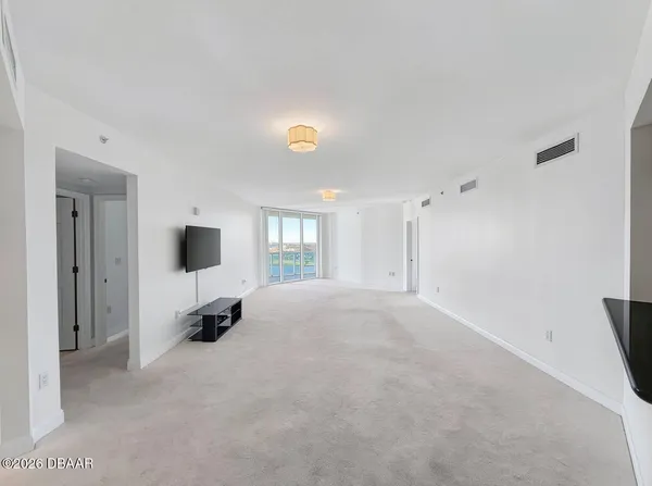 a view of empty room with a flat screen tv