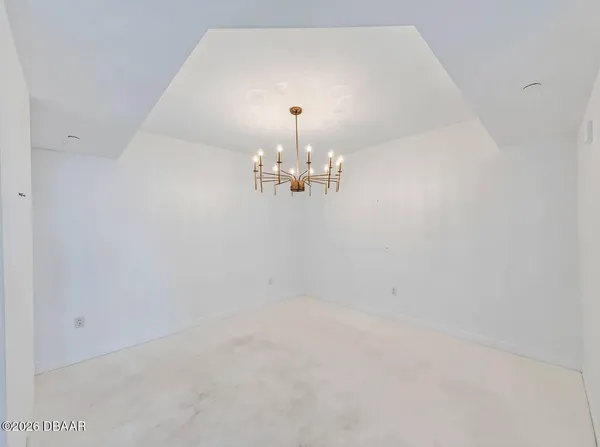 a view of a chandelier fan and fire place