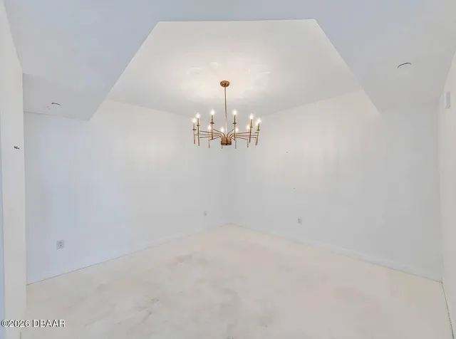 a view of a chandelier fan and fire place