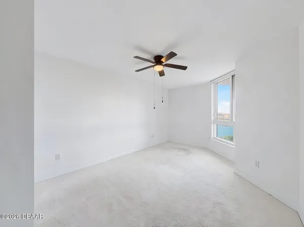 a view of an empty room with a window