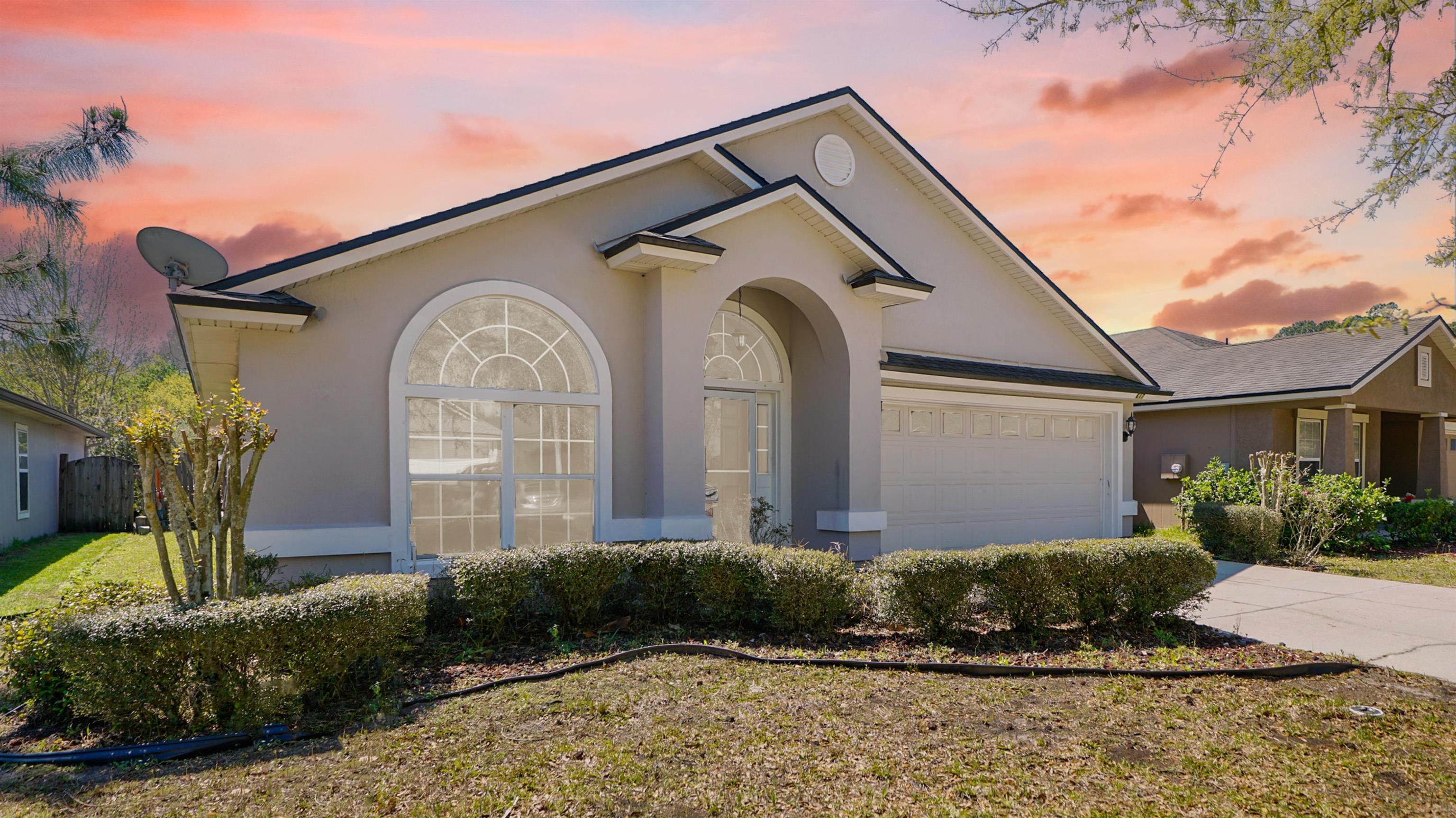a front view of a house with garden