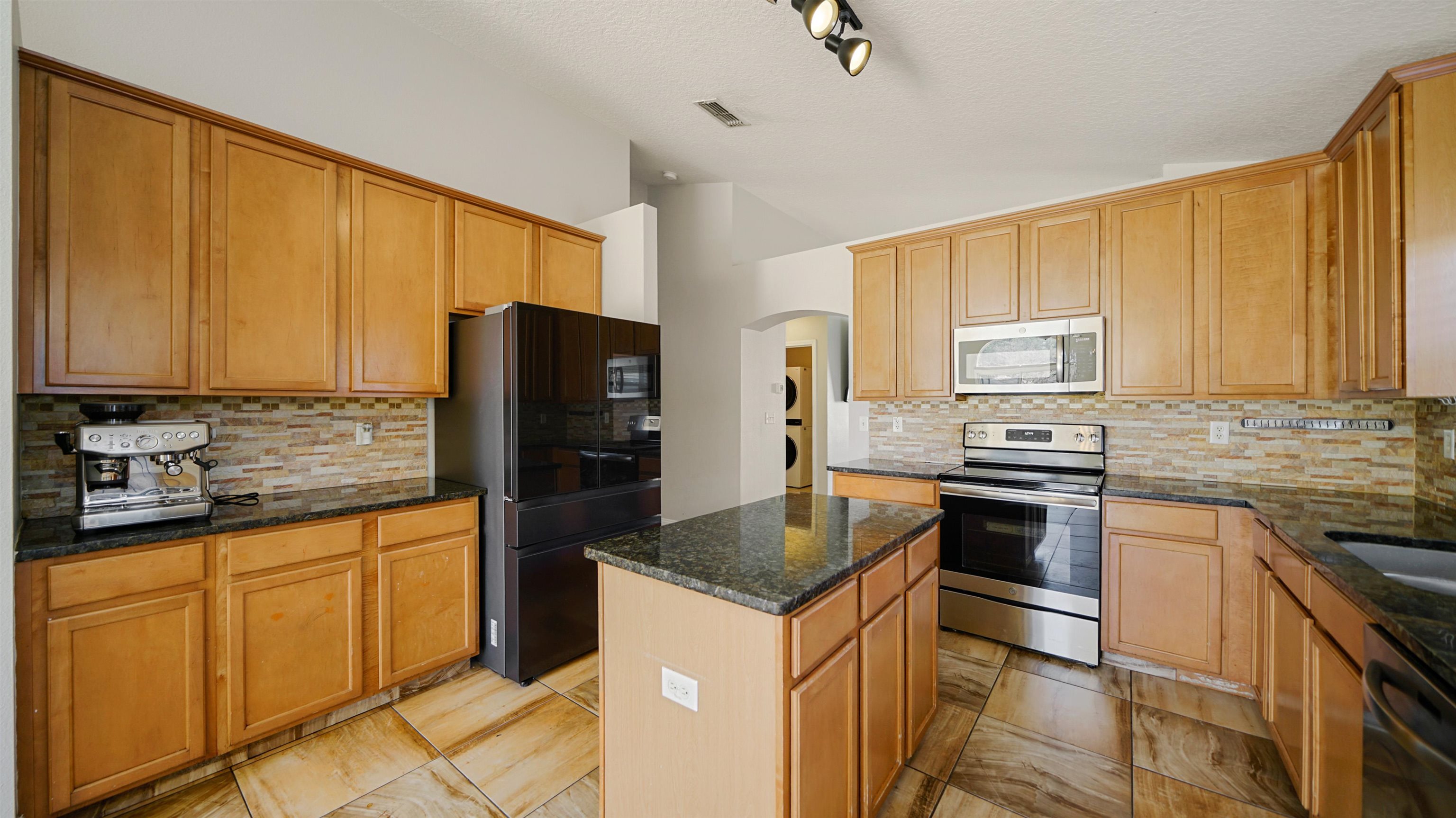 617 Birchbark Trail St. Augustine, FL 32092 - Photo 7 of 41 a kitchen with granite countertop a refrigerator stove and sink