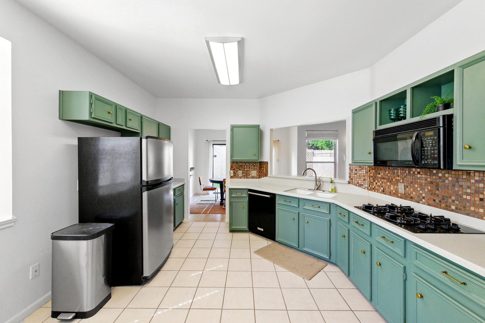 5807 Convict Hill Road Austin, TX 78749 - Photo 12 of 27 This galley-style kitchen offers ample cabinetry, updated appliances, and seamless access to the dining area for everyday convenience.