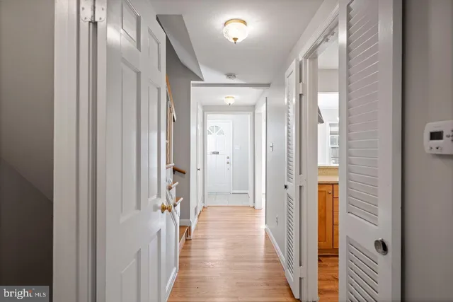 a view of a hallway with a wooden door