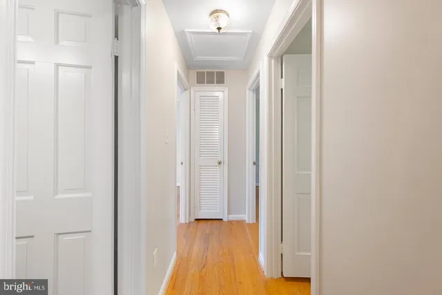a view of a hallway with wooden floor