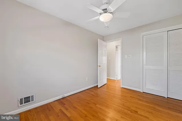 a view of an empty room with wooden floor