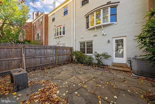 a view of a backyard with plants and wooden fence