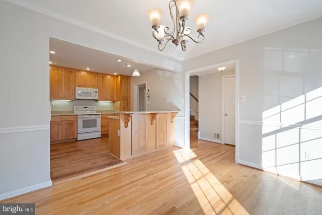 a view of a kitchen with wooden floor and a window