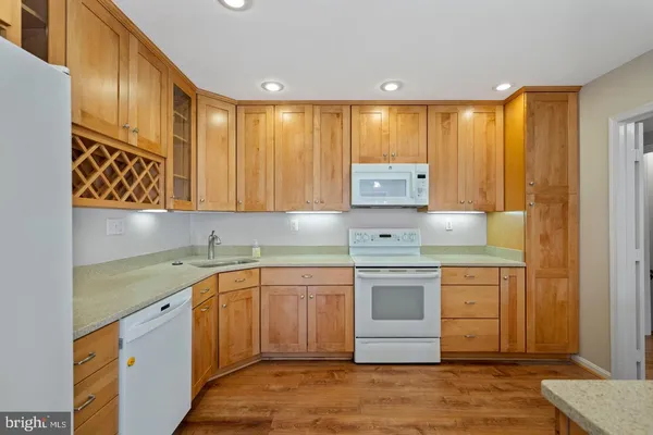 a kitchen with stainless steel appliances granite countertop a sink and cabinets
