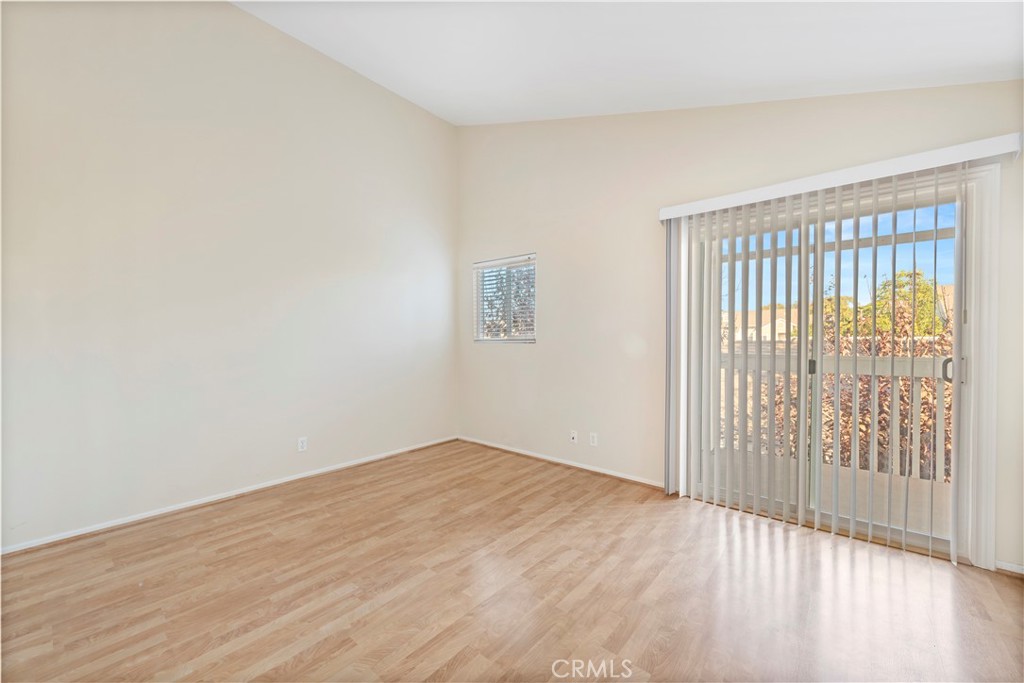 34110 Selva Road, Unit 323 Dana Point, CA 92629 - Photo 12 of 16 a view of an empty room with wooden floor and a window