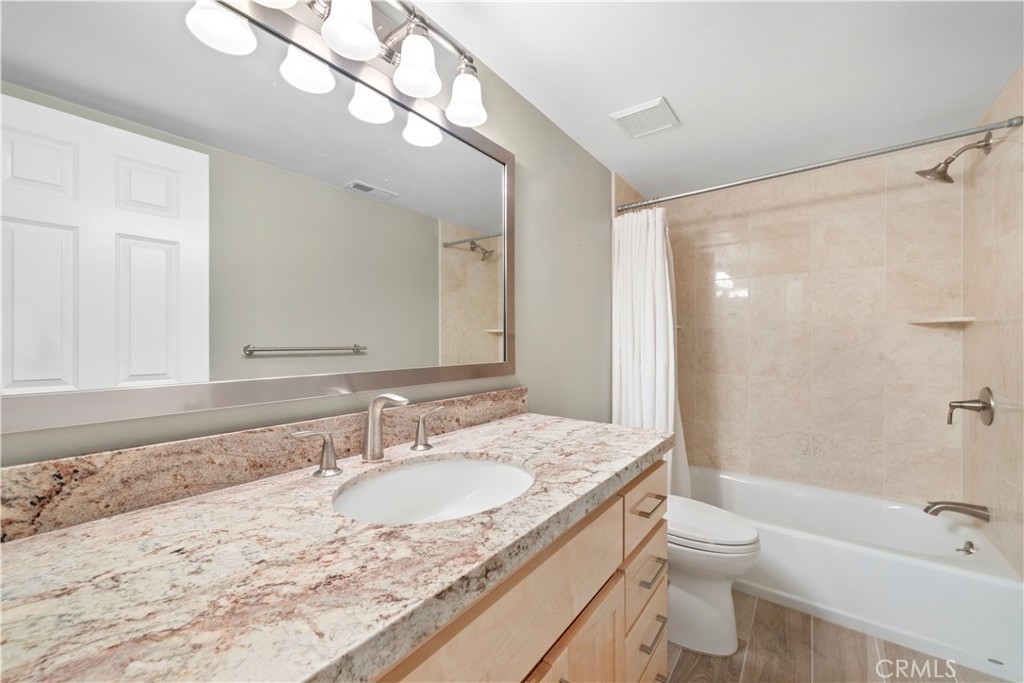 34110 Selva Road, Unit 323 Dana Point, CA 92629 - Photo 6 of 16 a bathroom with a granite countertop sink toilet and shower