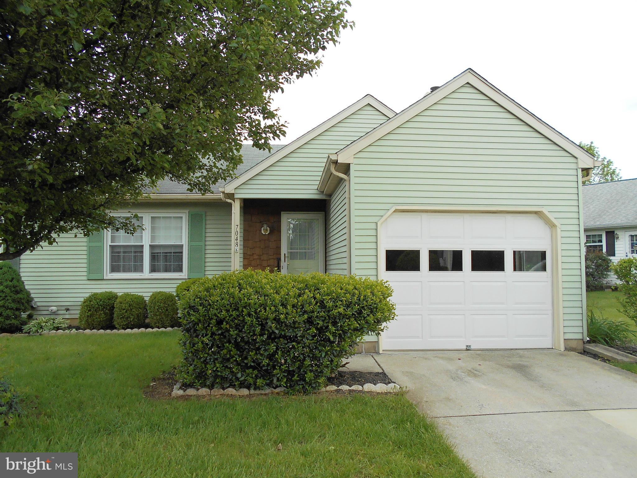 7048 Catalpa Road Frederick, MD 21703 - Photo 1 of 26 a front view of a house with a garden