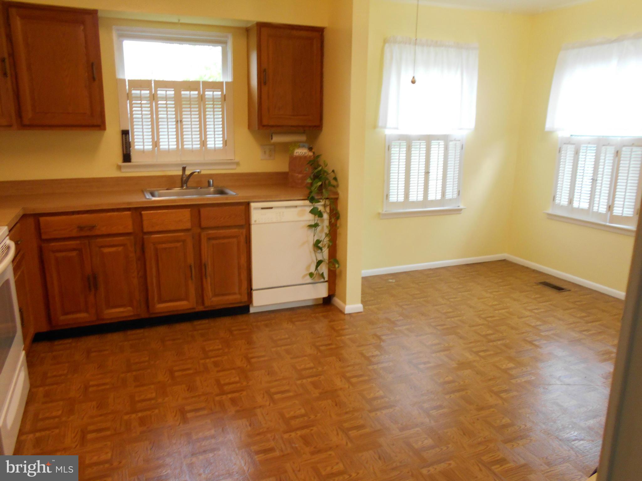 7048 Catalpa Road Frederick, MD 21703 - Photo 11 of 26 a view of a kitchen with wooden floor and windows