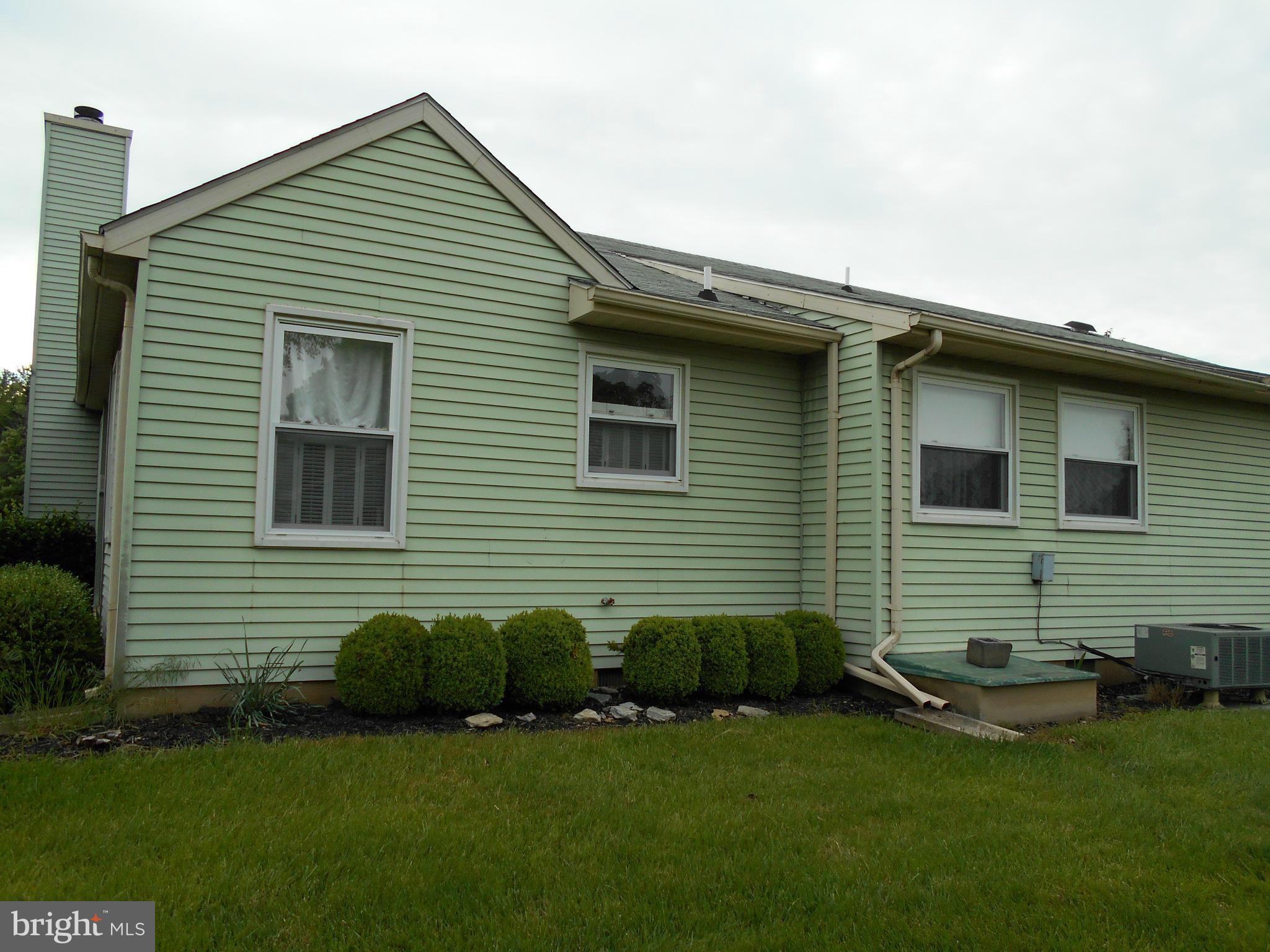 7048 Catalpa Road Frederick, MD 21703 - Photo 24 of 26 a front view of a house with a garden