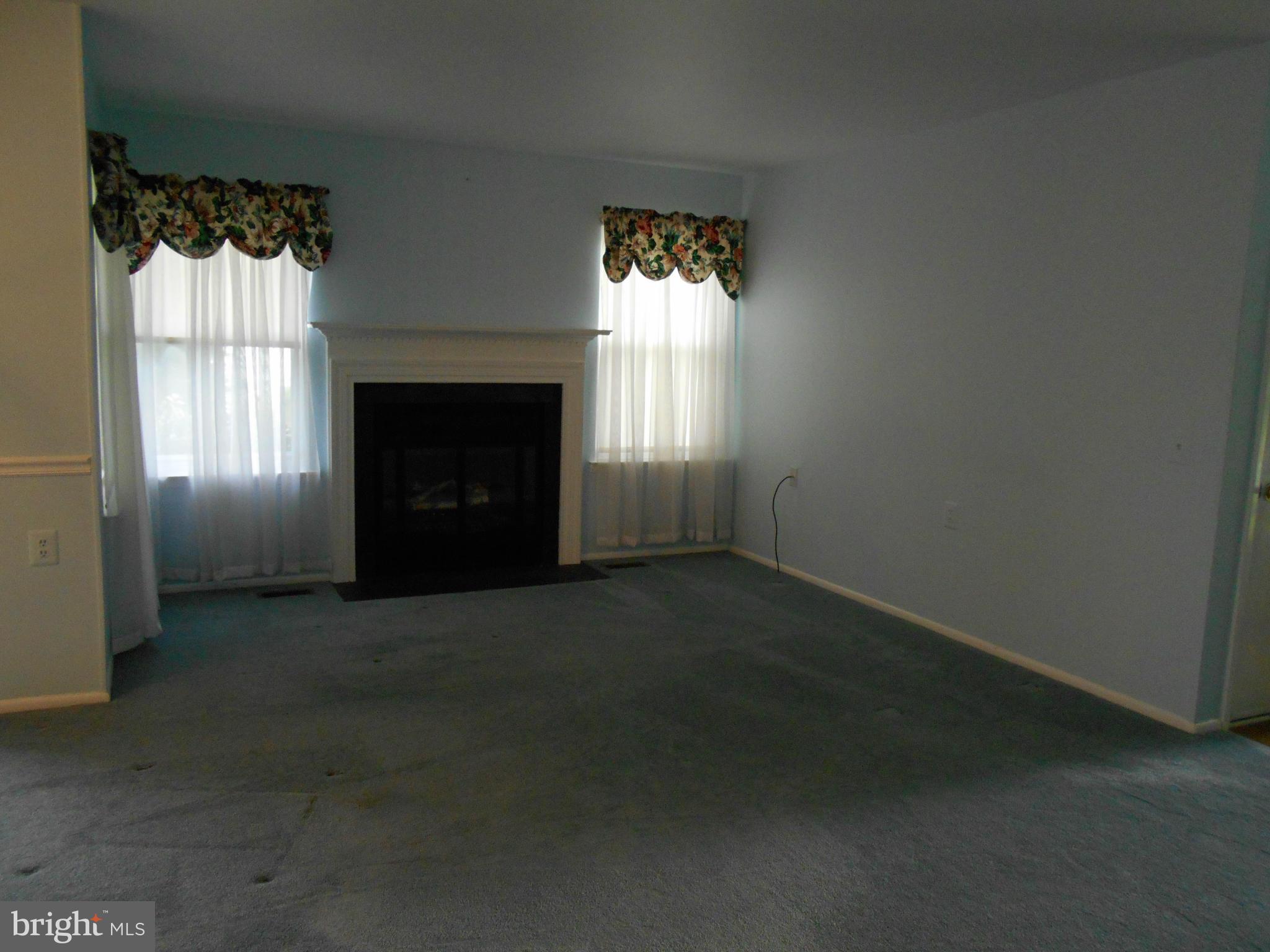 7048 Catalpa Road Frederick, MD 21703 - Photo 6 of 26 an empty room with windows and fireplace