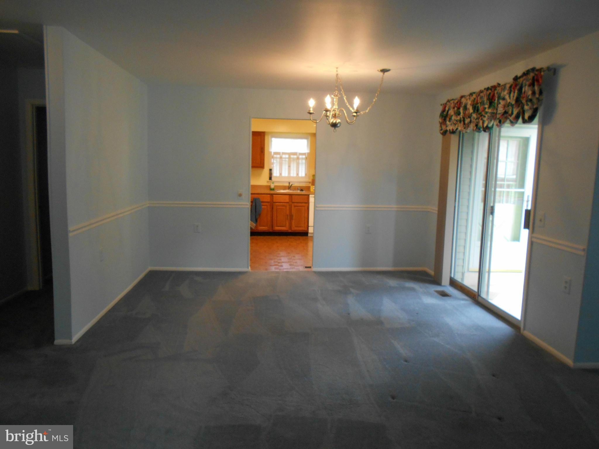7048 Catalpa Road Frederick, MD 21703 - Photo 7 of 26 a view of a big room with chandelier fan and windows