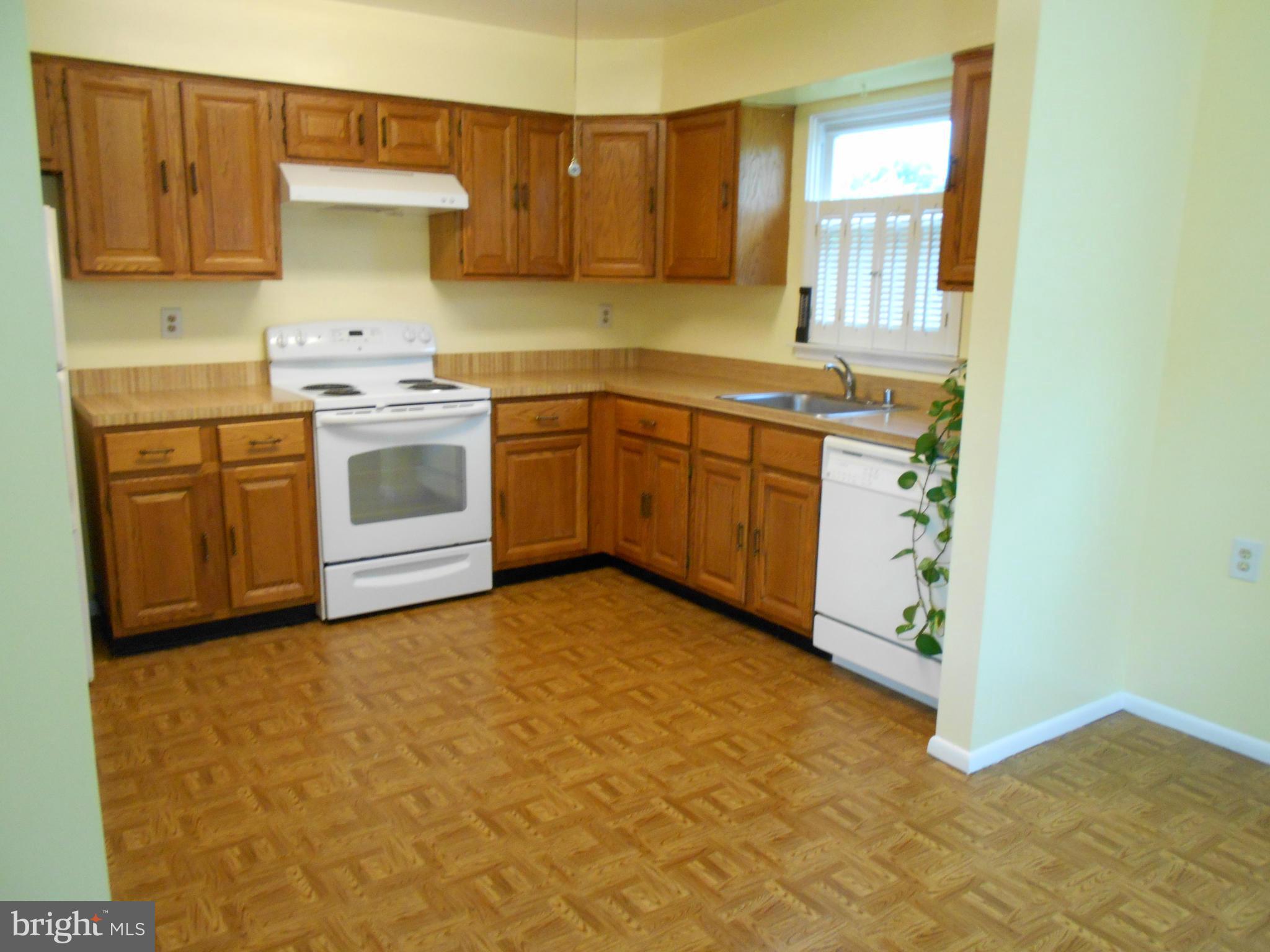 7048 Catalpa Road Frederick, MD 21703 - Photo 9 of 26 a kitchen with a stove a sink and a window