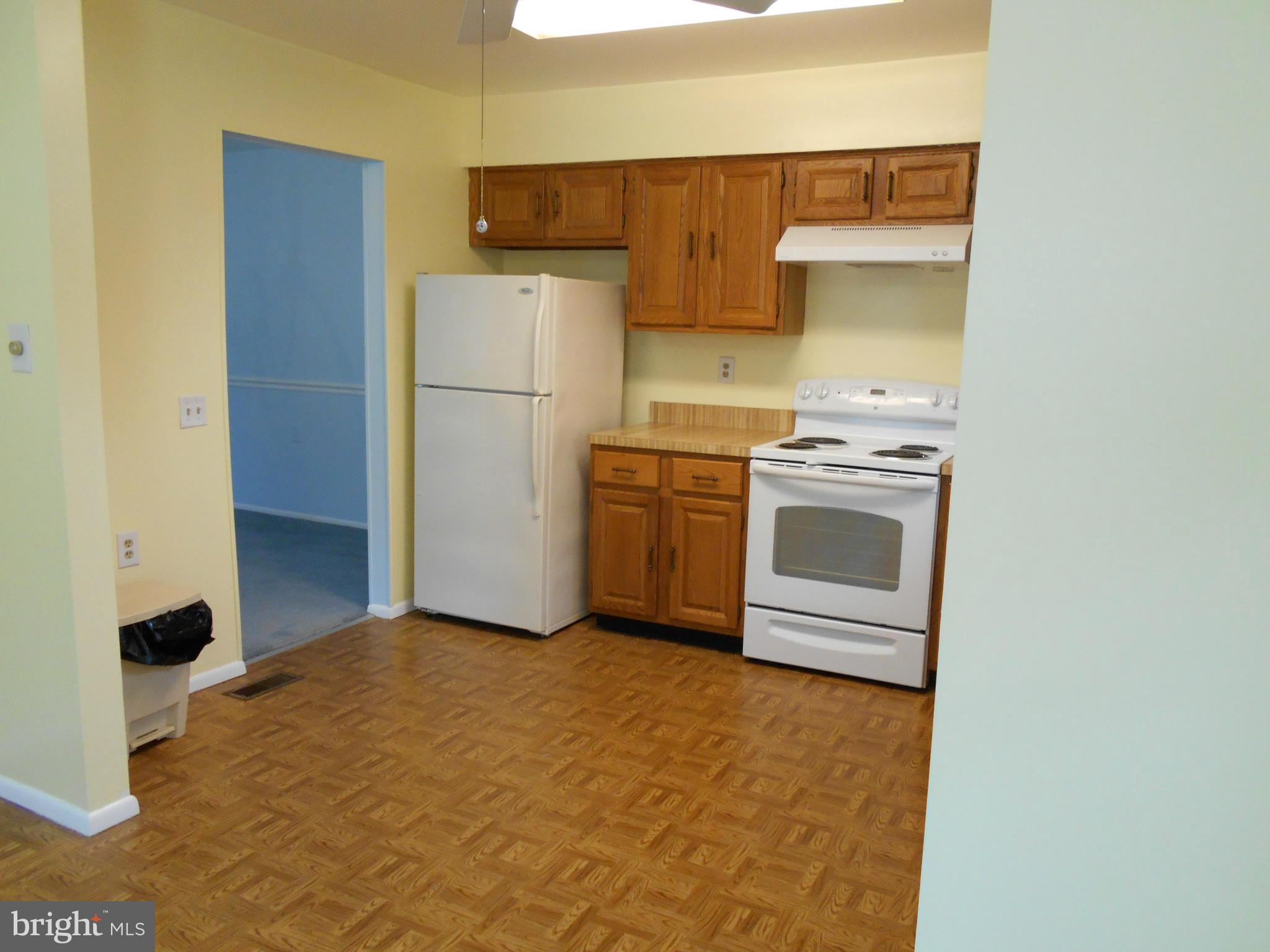 7048 Catalpa Road Frederick, MD 21703 - Photo 10 of 26 a kitchen with a stove a refrigerator and a cabinets