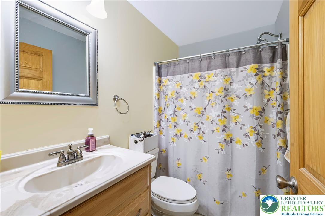 6970 Silver Crest Road Nazareth, PA 18064 - Photo 26 of 35 A well-maintained full bathroom offers convenient facilities with a vanity and shower.