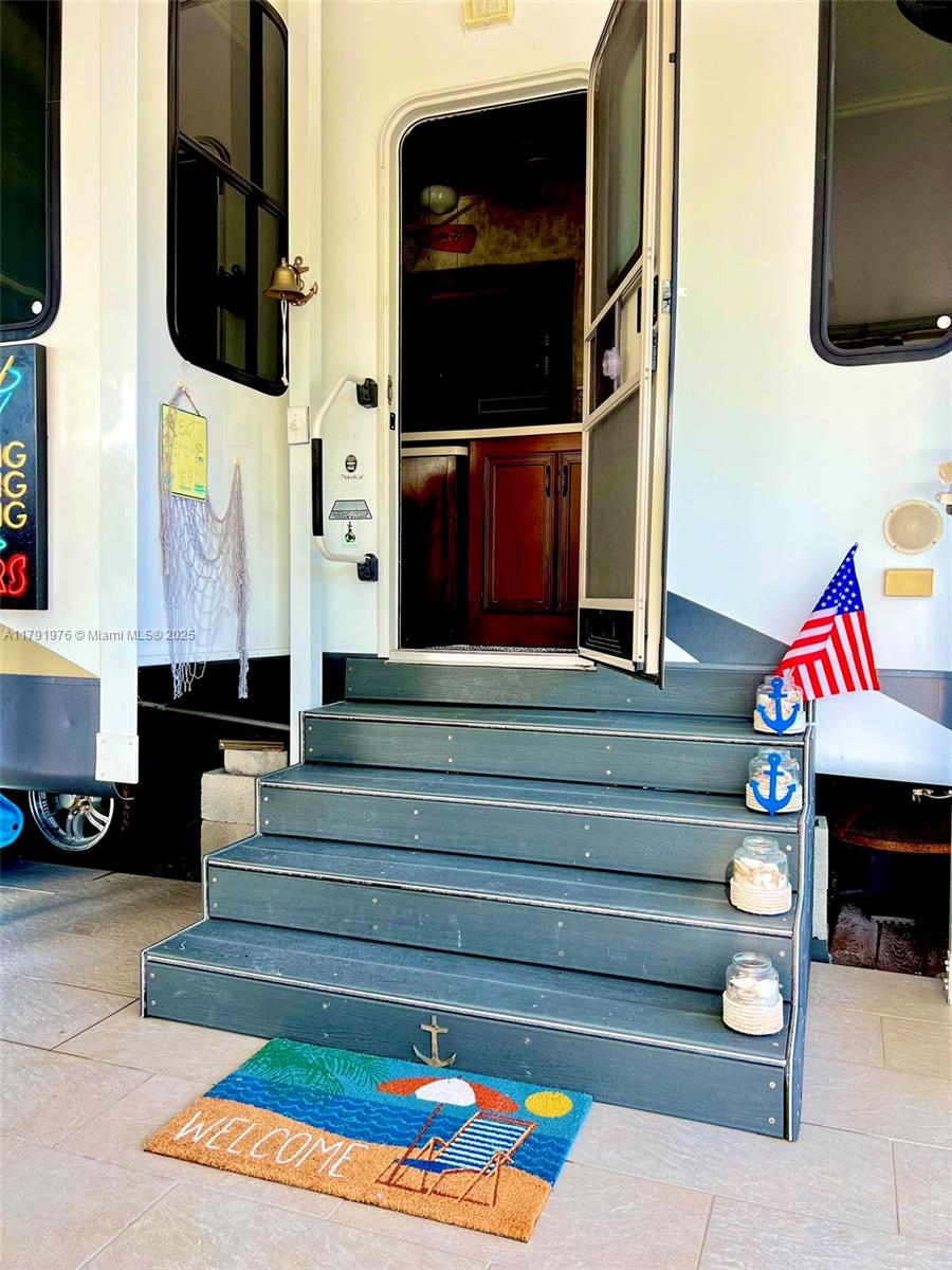 325 Calusa Street Key Largo, FL 33037 - Photo 12 of 48 a living room with furniture and a flat screen tv