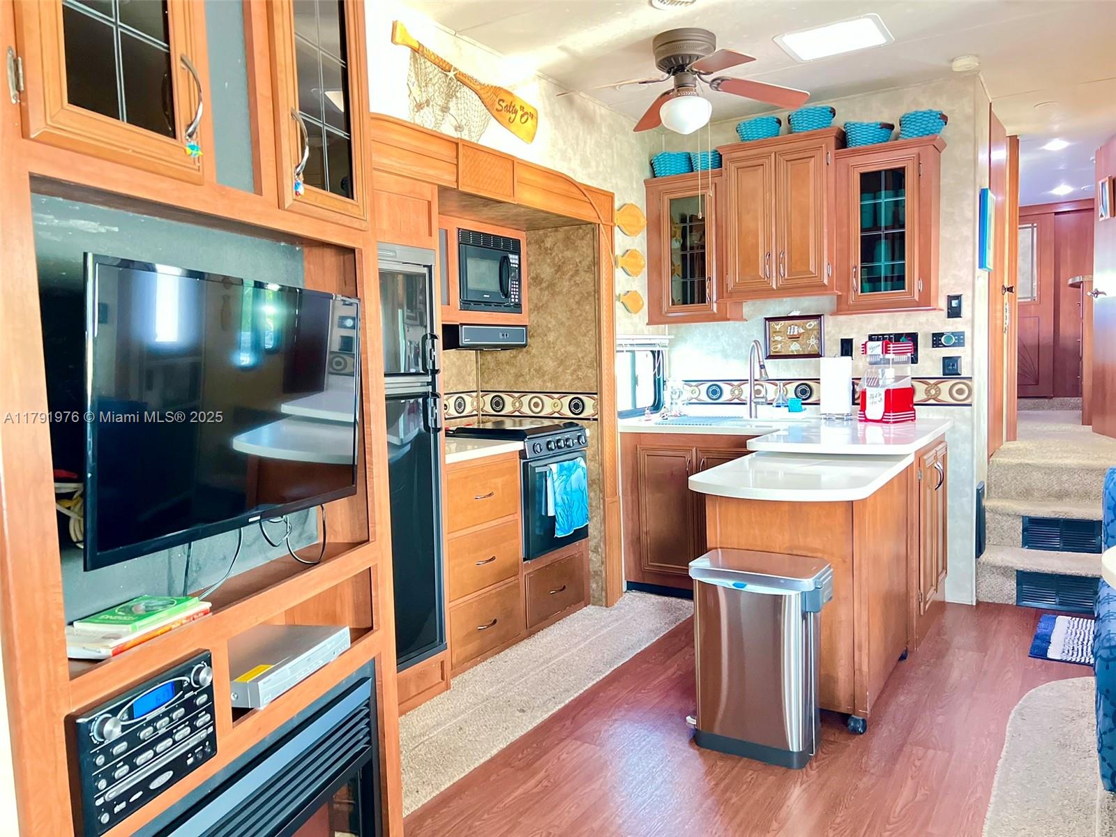 325 Calusa Street Key Largo, FL 33037 - Photo 14 of 48 a kitchen view with stainless steel appliances granite countertop a stove a sink and a microwave