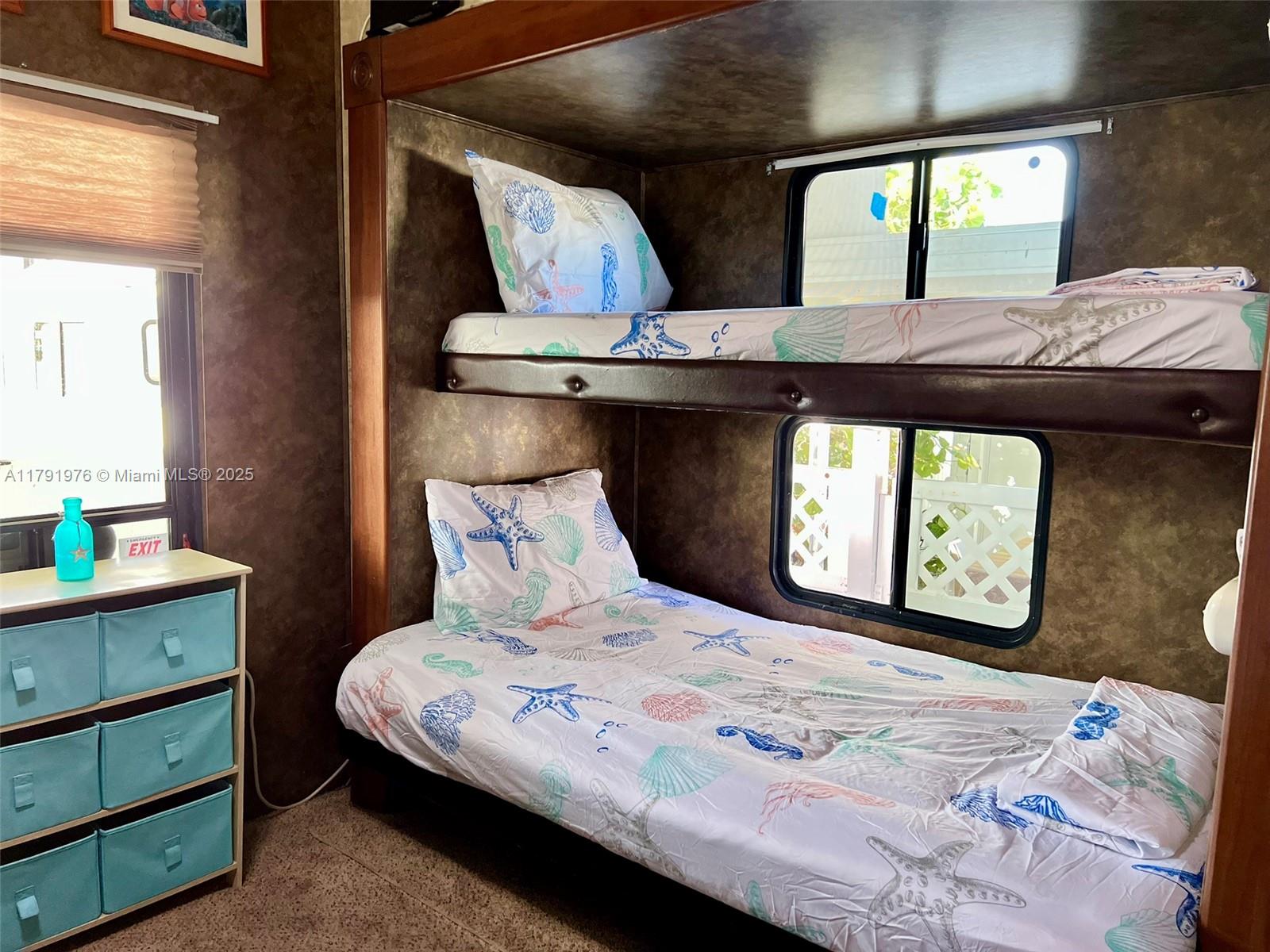 325 Calusa Street Key Largo, FL 33037 - Photo 16 of 48 a bedroom with a bed a mirror and a window