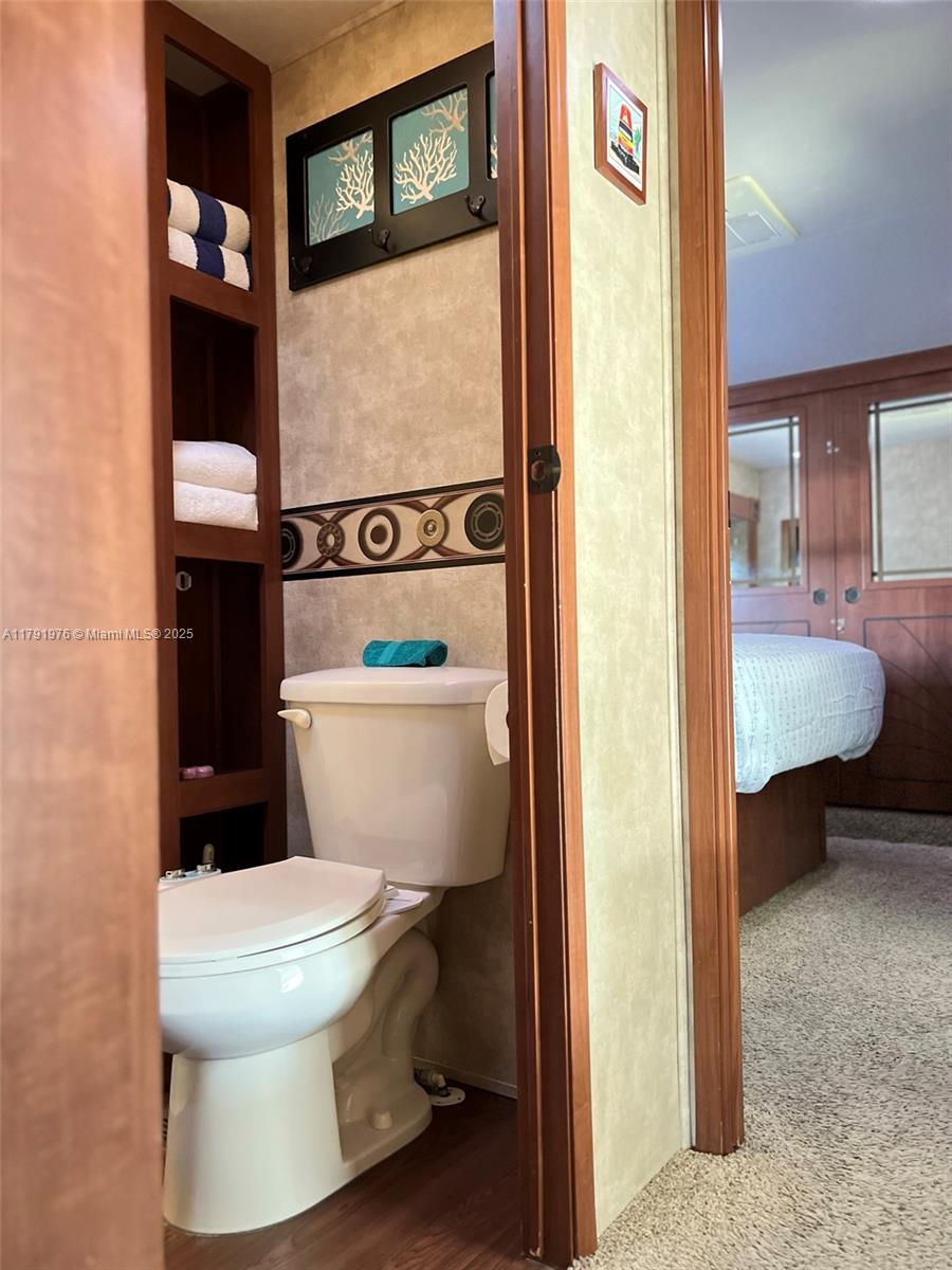 325 Calusa Street Key Largo, FL 33037 - Photo 21 of 48 a white toilet sitting next to a bathroom sink