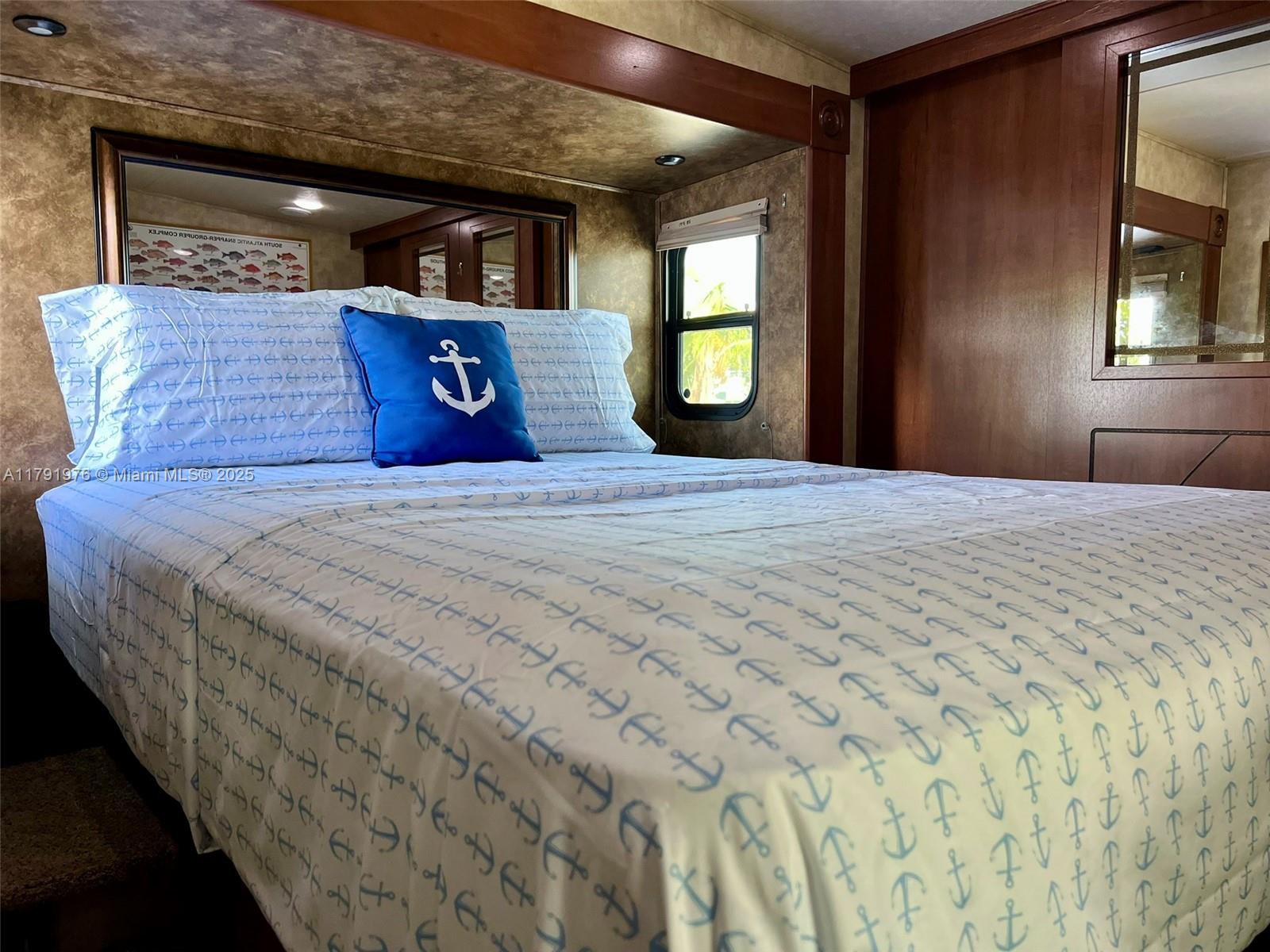 325 Calusa Street Key Largo, FL 33037 - Photo 22 of 48 a bedroom with a bed and window