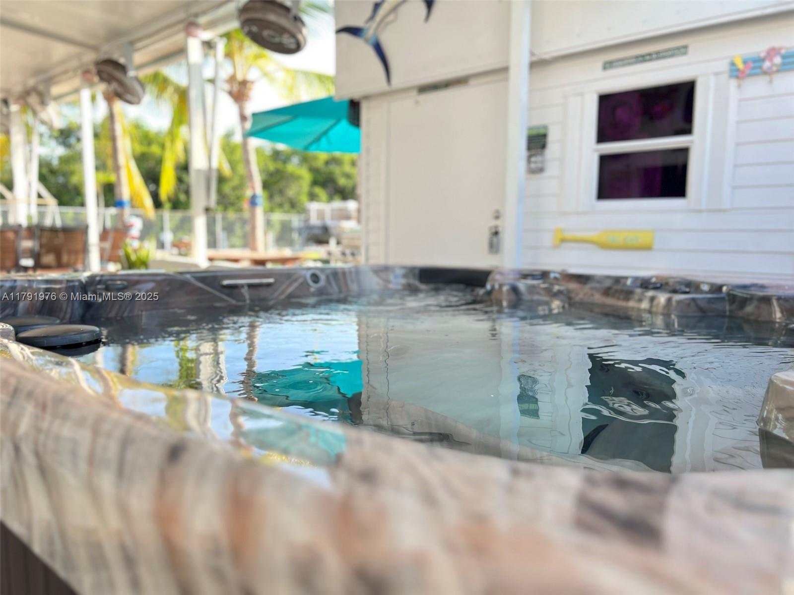 325 Calusa Street Key Largo, FL 33037 - Photo 27 of 48 a kitchen with a stove a sink and a wooden cabinets