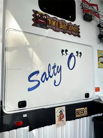 a view of backyard with wooden fence and a large tree