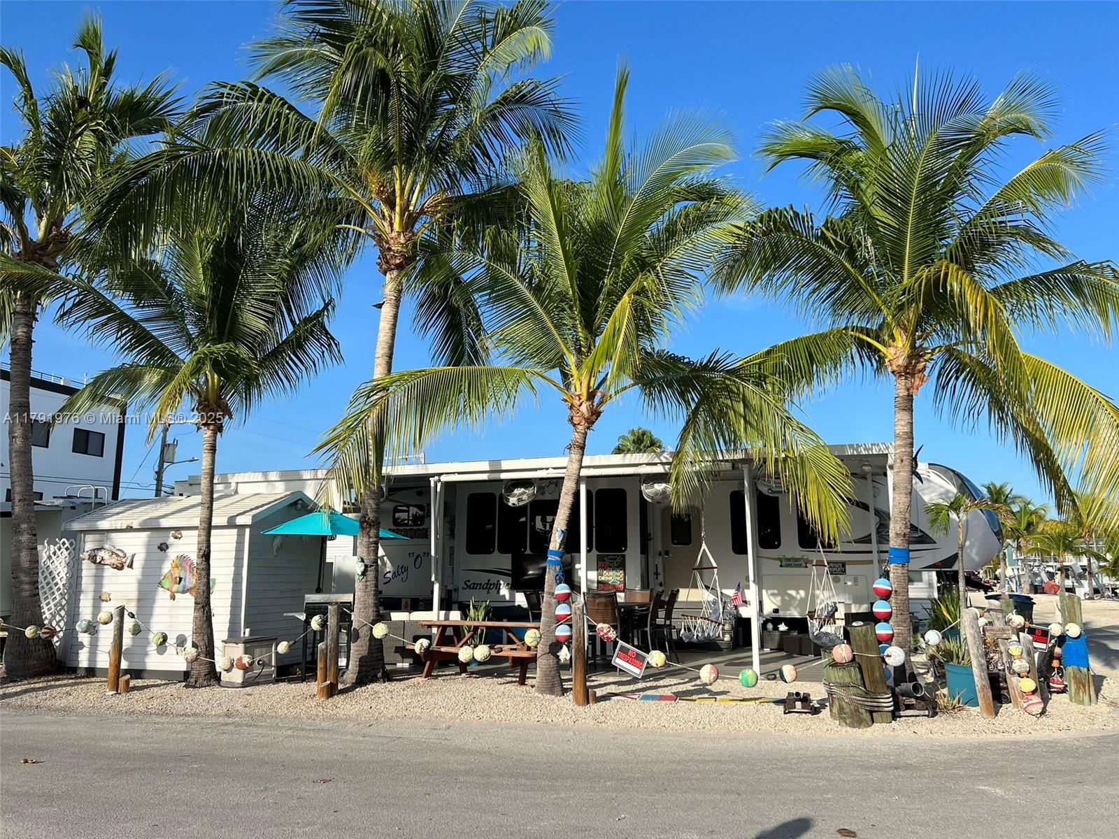 325 Calusa Street Key Largo, FL 33037 - Photo 3 of 48 a view of street with sitting area