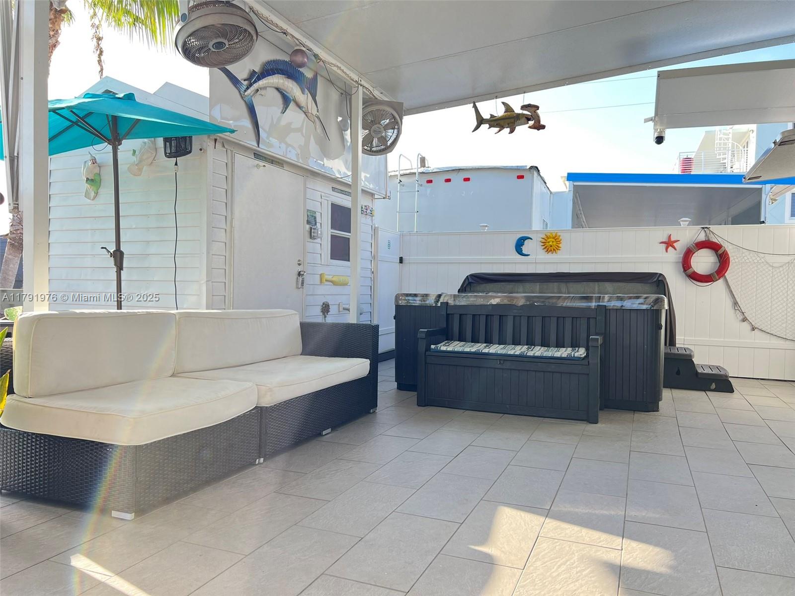 325 Calusa Street Key Largo, FL 33037 - Photo 9 of 48 a living room with a couch and a table