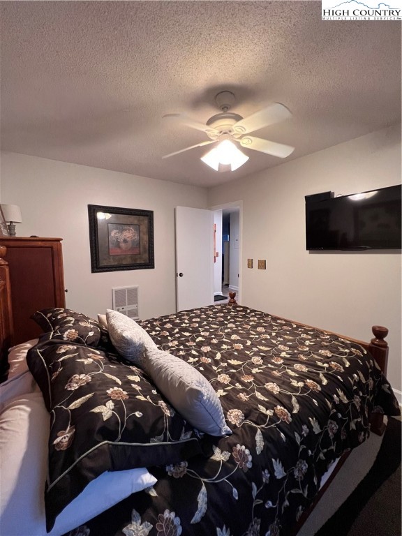 301 Pinnacle Inn Road, Unit 4116 Beech Mountain, NC 28604 - Photo 8 of 16 a bedroom with a bed and a television