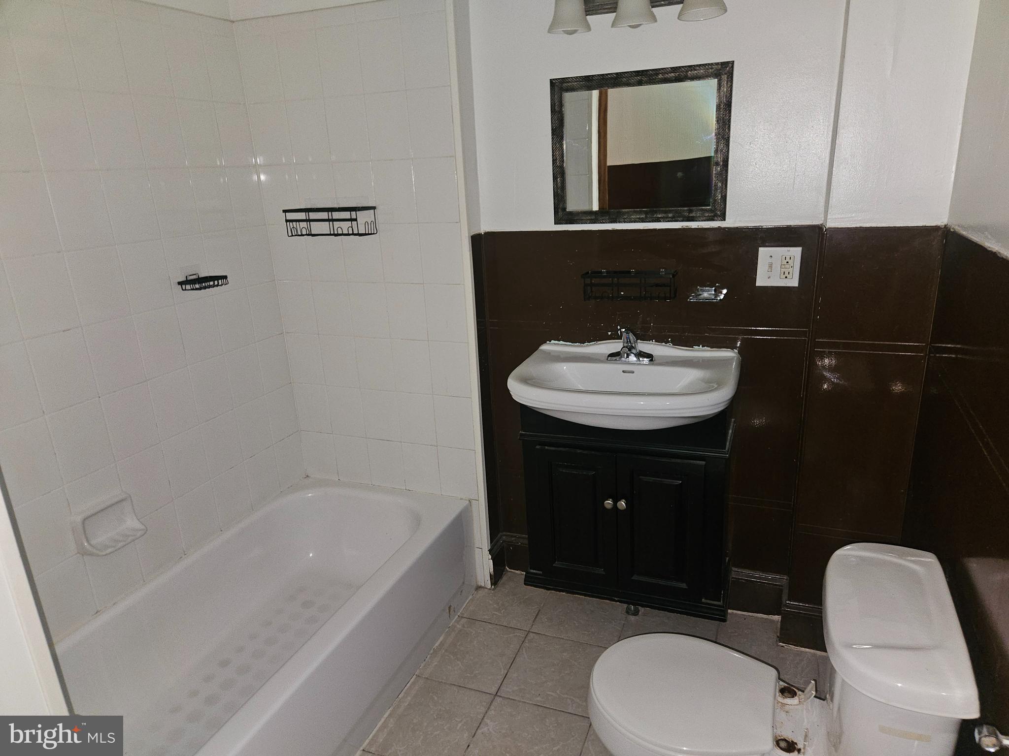 106 North 11th Street Pottsville, PA 17901 - Photo 4 of 6 a bathroom with a sink and a mirror