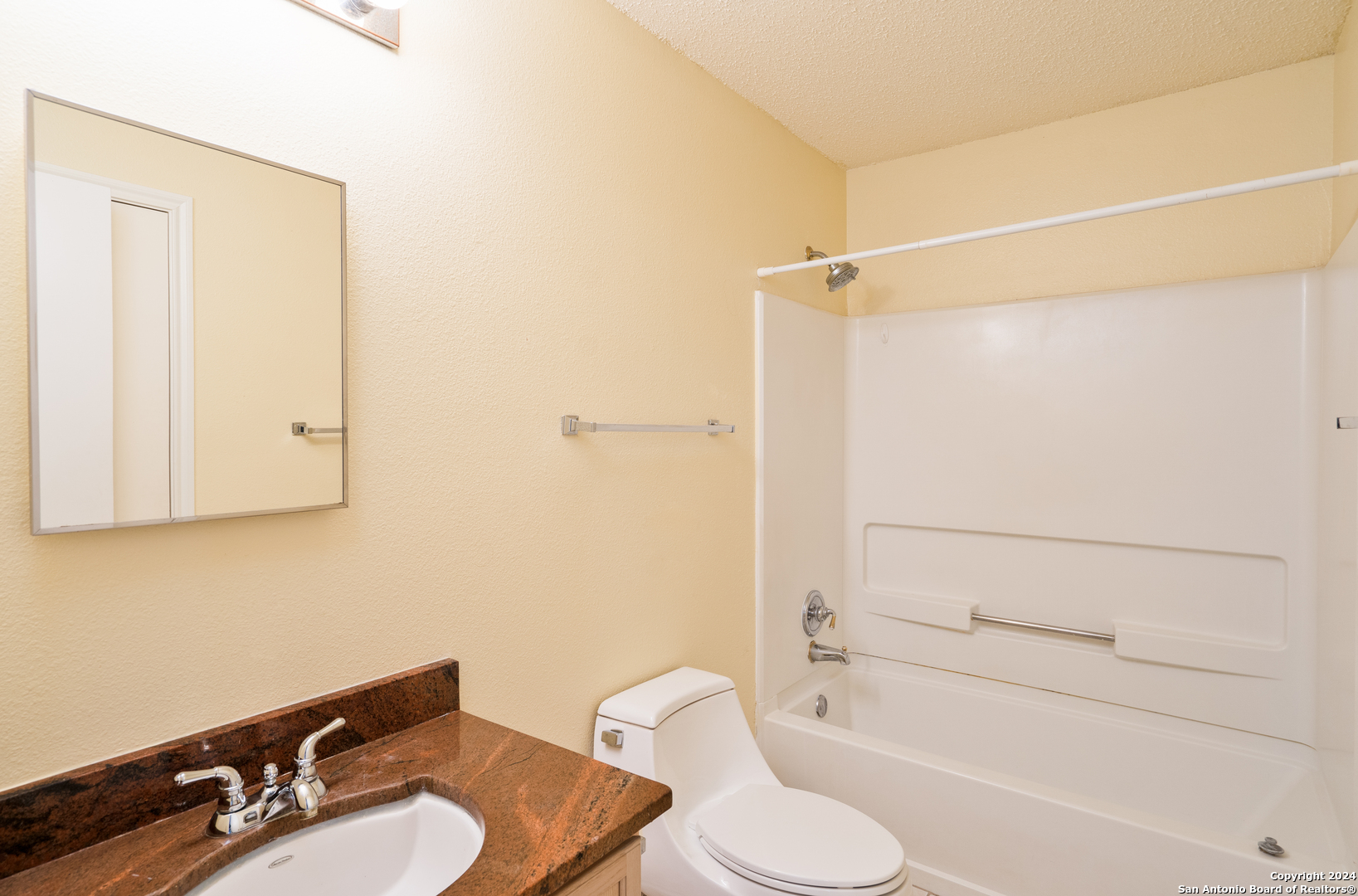 9243 Windward Trace San Antonio, TX 78254 - Photo 12 of 24 a bathroom with a sink toilet and shower