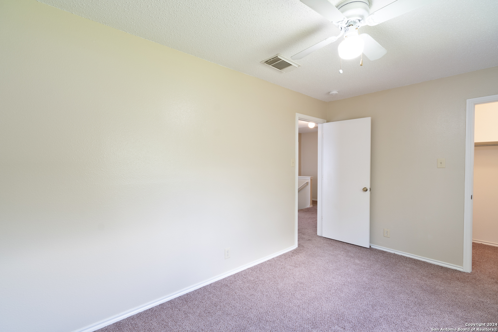 9243 Windward Trace San Antonio, TX 78254 - Photo 14 of 24 an empty room with a chandelier fan and glass door