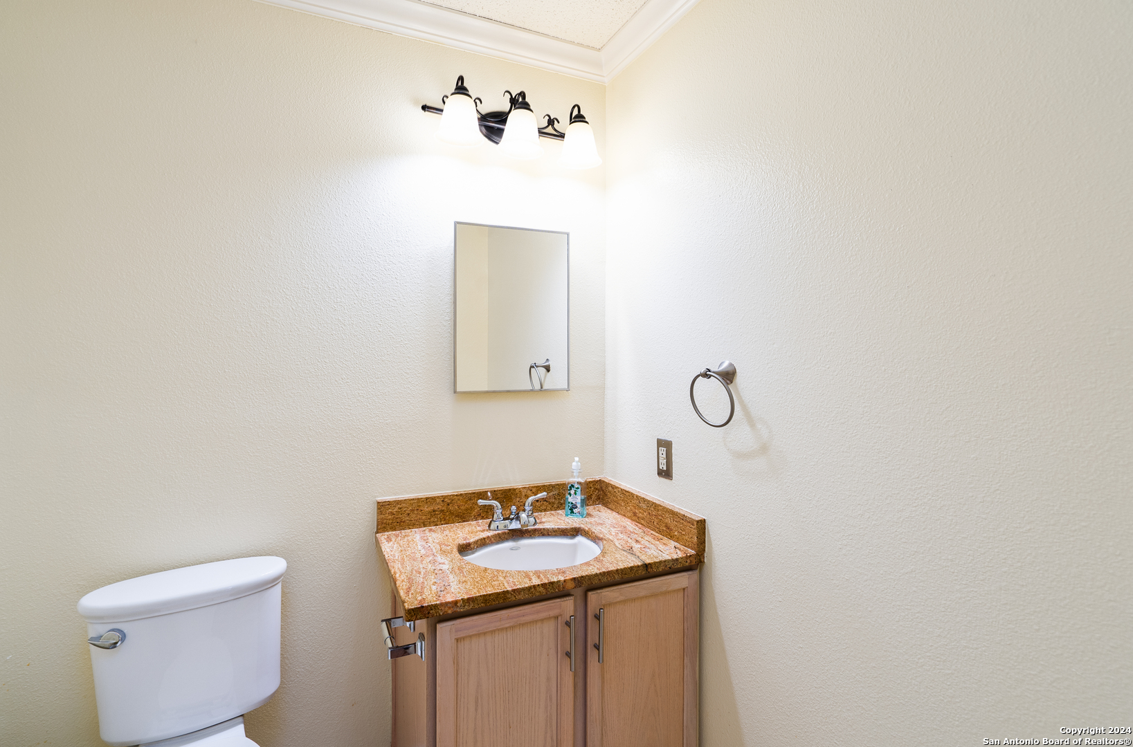 9243 Windward Trace San Antonio, TX 78254 - Photo 21 of 24 a bathroom with a toilet sink and mirror