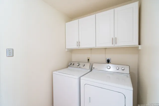 a view of storage and utility room with washer and dryer