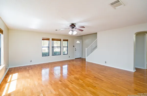 wooden floor in an empty room with a window