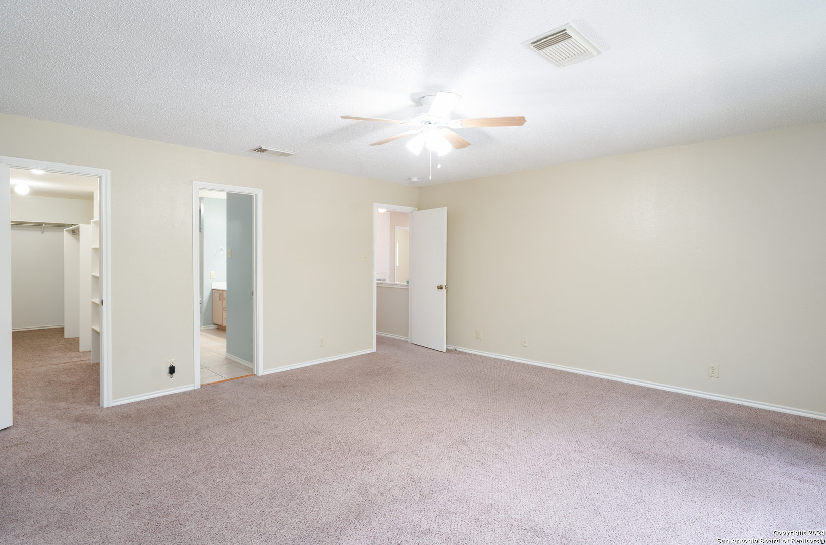 9243 Windward Trace San Antonio, TX 78254 - Photo 9 of 24 an empty room with closet and a ceiling fan