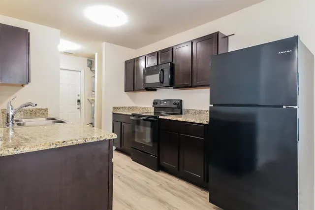 a kitchen with a refrigerator and a sink