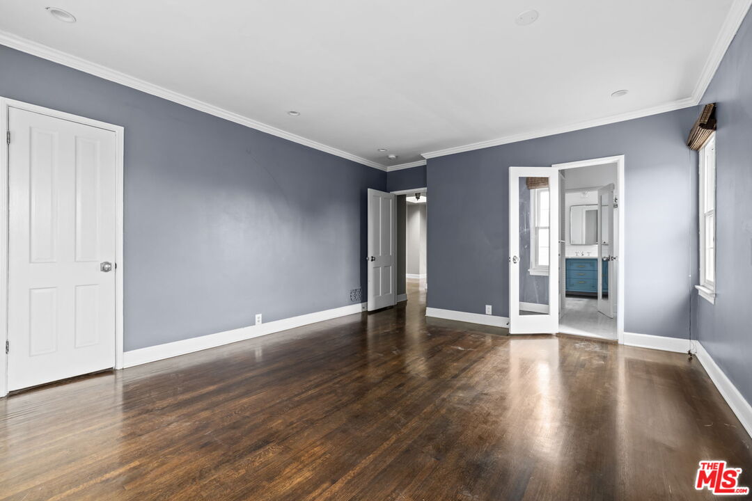 1307 South Rimpau Boulevard Los Angeles, CA 90019 - Photo 15 of 22 a view of an empty room with wooden floor