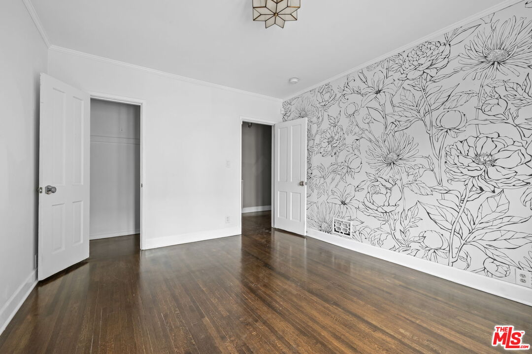 1307 South Rimpau Boulevard Los Angeles, CA 90019 - Photo 18 of 22 wooden floor with a bench in a room