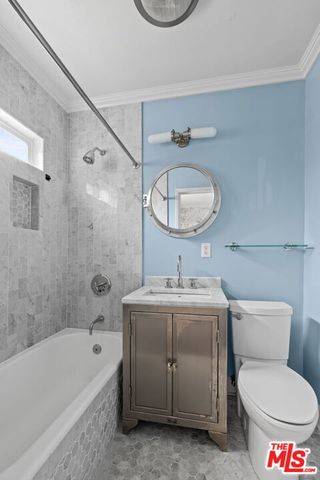 a bathroom with a granite countertop toilet a sink and bathtub