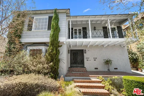a view of a house with potted plants