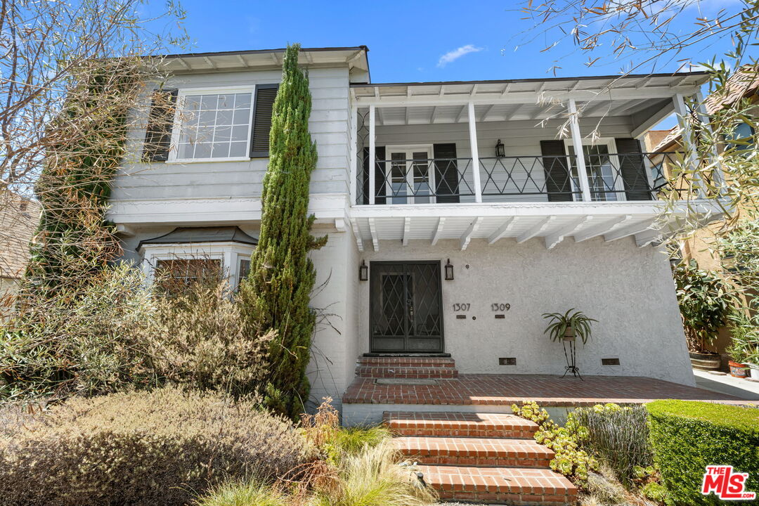 1307 South Rimpau Boulevard Los Angeles, CA 90019 - Photo 2 of 22 a view of a house with potted plants