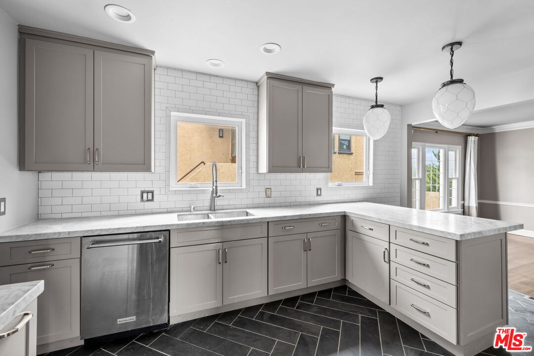 1307 South Rimpau Boulevard Los Angeles, CA 90019 - Photo 5 of 22 a kitchen with a sink stove and cabinets